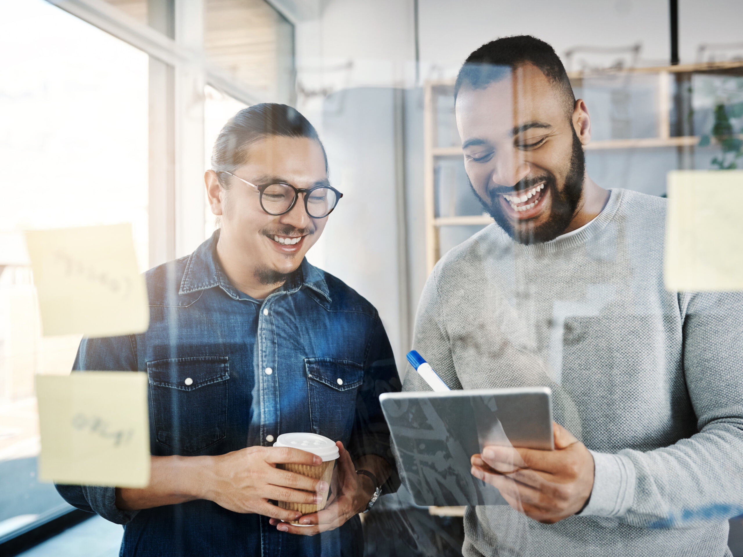 Two marketing partners work on their media planning strategy in a modern office
