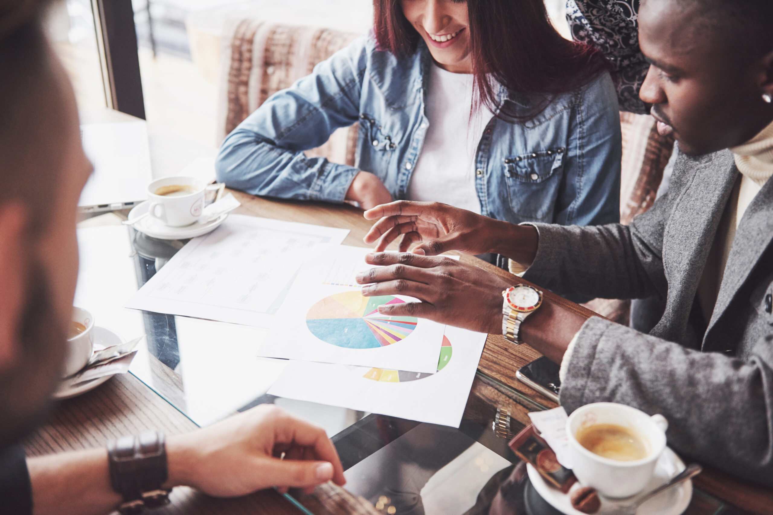 Partner marketing professionals go over financial spreadsheets and discuss how to increase revenue.