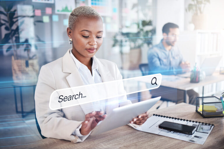 A Black professional woman searches on her tablet for information with a hologram overlay showcasing SEO and AI visibility.