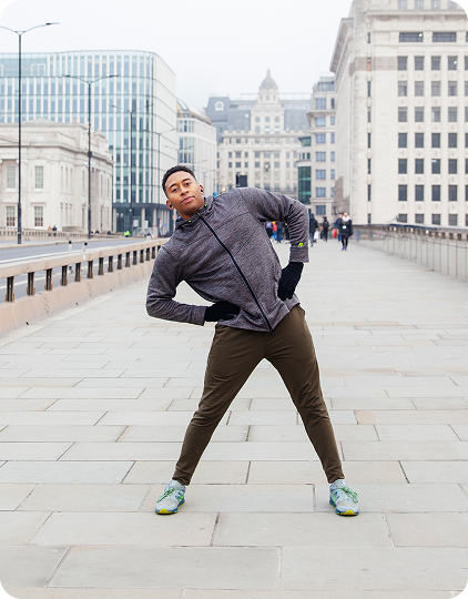 A fitness creator for a health and wellness brand stretches before his run.