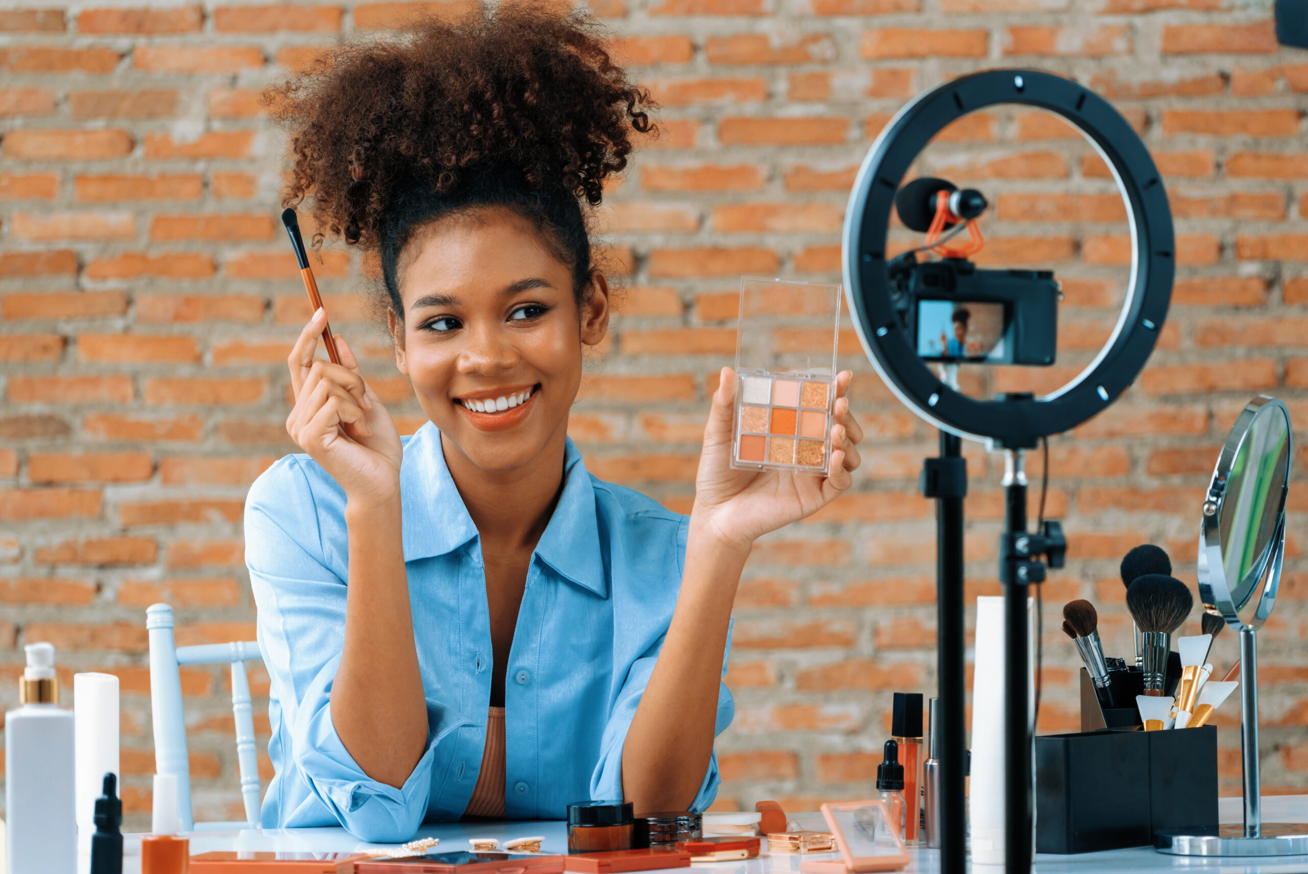 A woman influencer shoots a live streaming video review for a beauty brand